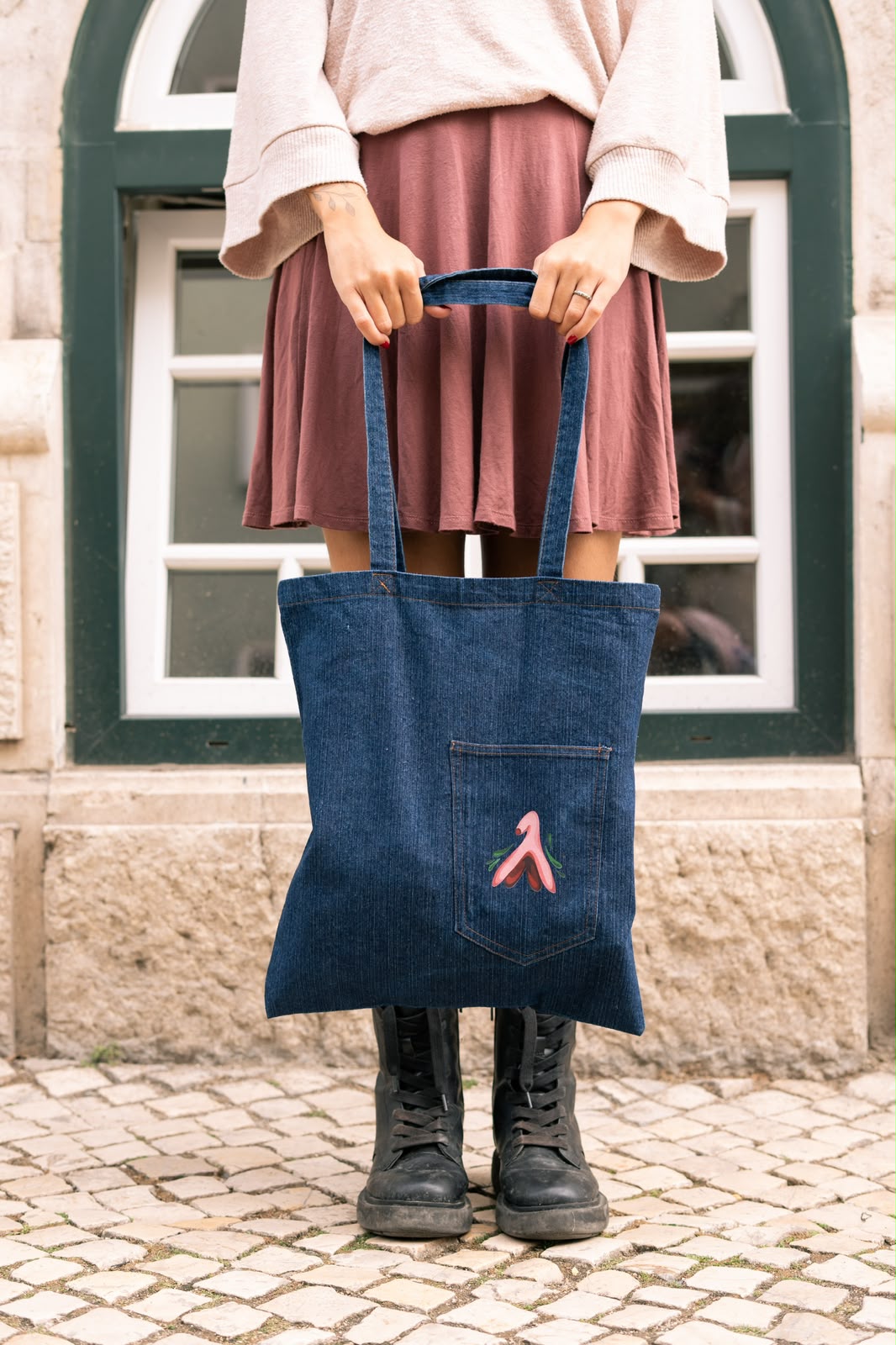 Denim tote bag with a clitoris illustration on the pocket