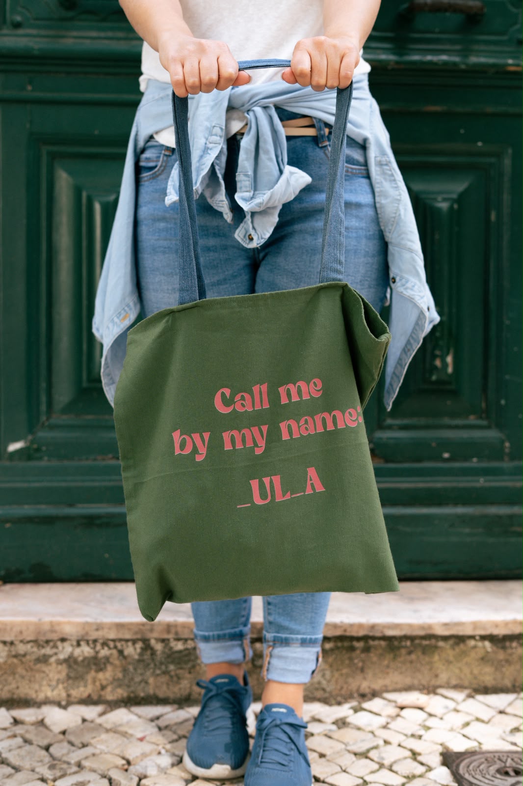 Green tote bag printed 'Call me by my name: _UL_A'
