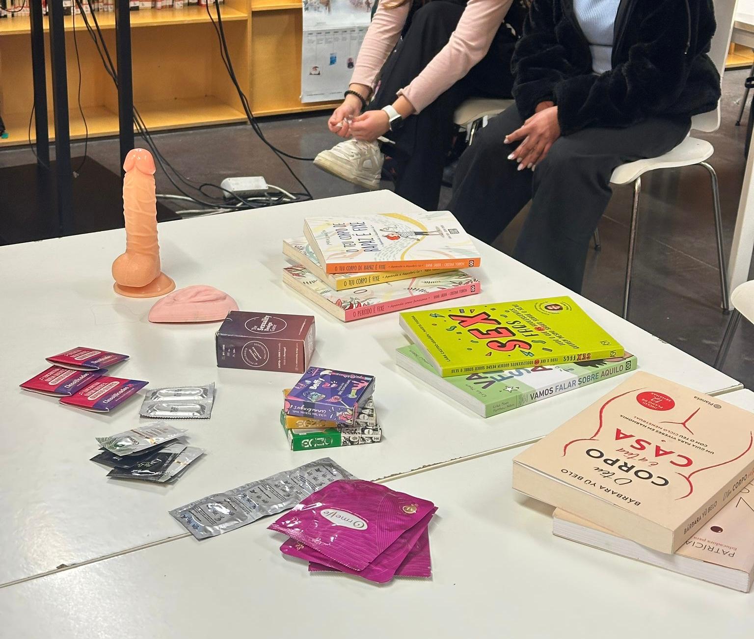 Table at a school session with anatomical models, condoms, internal condoms, card games and sex education books